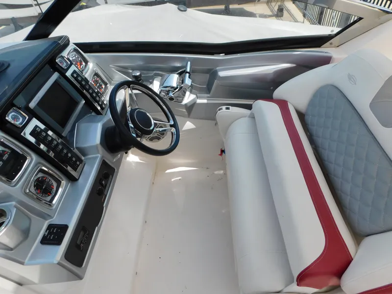 Slide: The Image of 2013 Chaparral 327 SSX boat cockpit with modern controls and comfortable seating. - 21