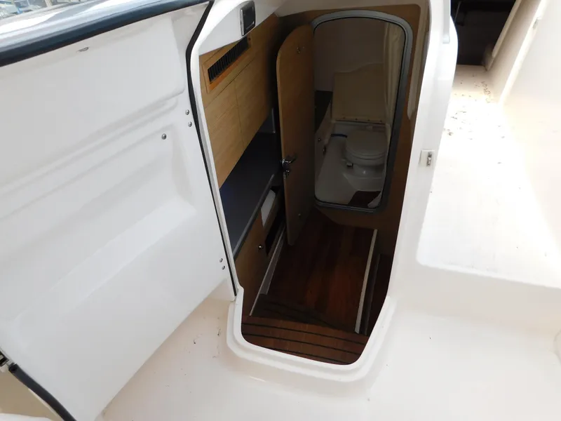 Slide: The Image of Interior view of 2013 Chaparral 327 SSX boat showing cabin entrance and bathroom. - 22