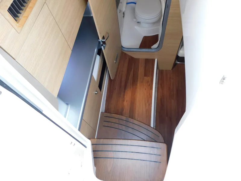 Slide: The Image of Interior of 2013 Chaparral 327 SSX boat with wooden flooring and compact bathroom. - 23