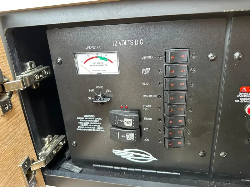 Slide: The Image of Control panel of a 2013 Chaparral 327 SSX boat with switches and voltage monitor. - 27