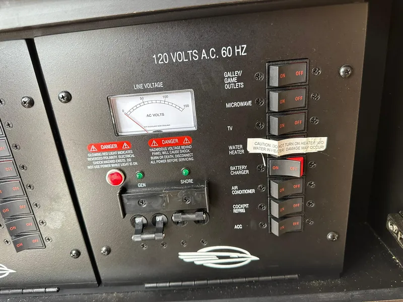 Slide: The Image of Electrical panel of a 2013 Chaparral 327 SSX boat, showing switches and voltage meter. - 28