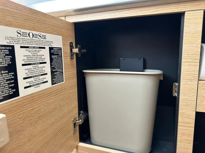 Slide: The Image of Cabinet with trash bin and "Save Our Seas" notice on Chaparral 327 SSX, 2013 model. - 29