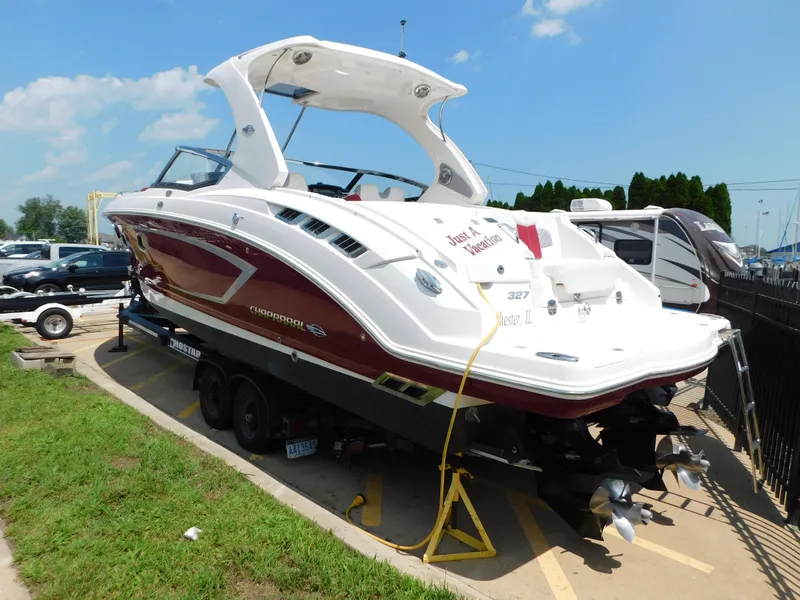 Slide: The Image of 2013 Chaparral 327 SSX boat on trailer, red and white design, parked outdoors. - 3