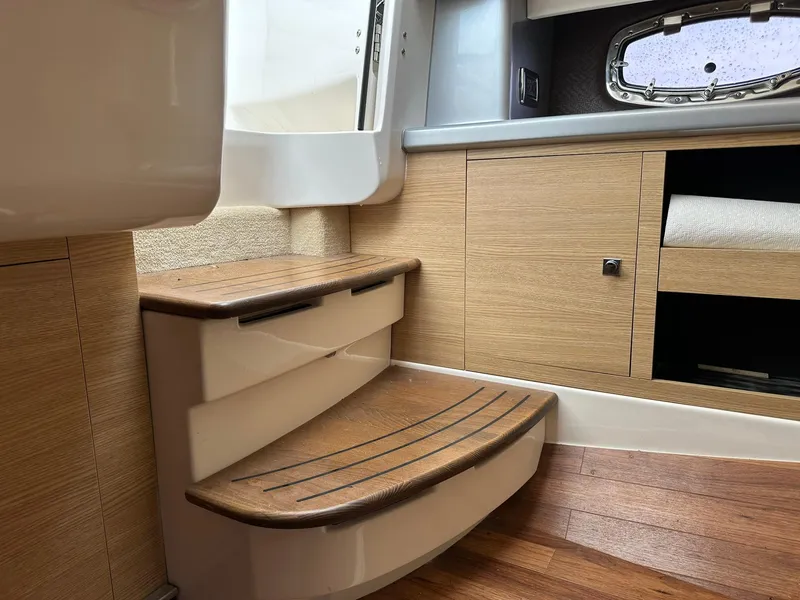 Slide: The Image of Interior of 2013 Chaparral 327 SSX boat with wooden steps and cabinetry. - 30