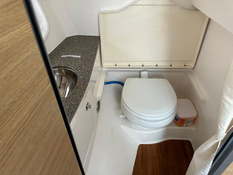 Slide: The Image of Compact bathroom in 2013 Chaparral 327 SSX boat with toilet and sink. - 33