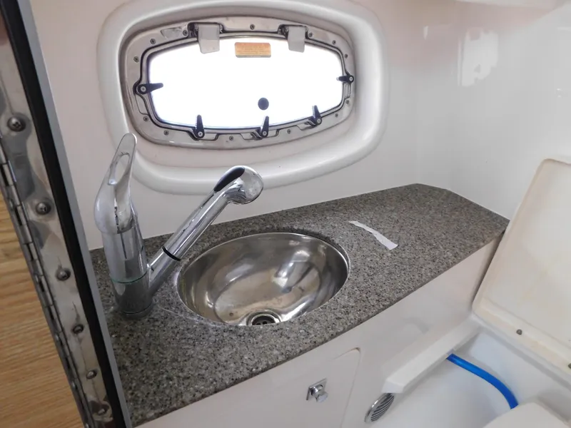 Slide: The Image of Chaparral 327 SSX 2013 boat interior with sink and porthole window. - 34