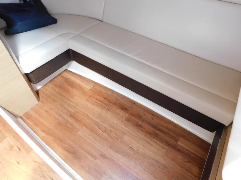 Slide: The Image of Interior of 2013 Chaparral 327 SSX with white seating and wooden flooring. - 35