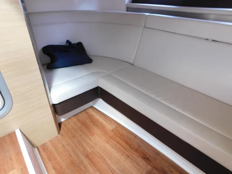 Slide: The Image of Interior of 2013 Chaparral 327 SSX boat with white seating and wooden flooring. - 36
