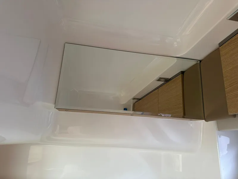 Slide: The Image of Interior of 2013 Chaparral 327 SSX boat with mirror and wooden cabinets. - 38