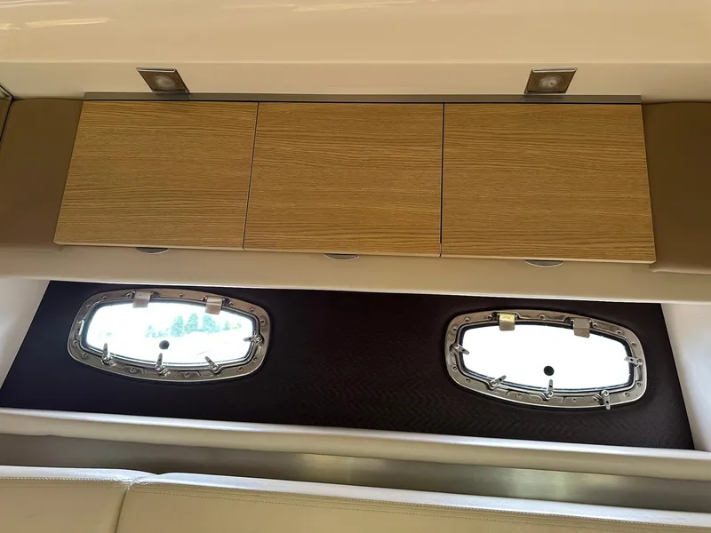 Slide: The Image of Interior of 2013 Chaparral 327 SSX with wooden cabinets and oval windows. - 39