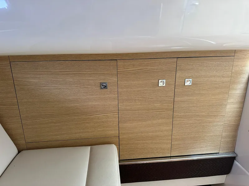 Slide: The Image of Interior view of 2013 Chaparral 327 SSX boat with wooden cabinetry and seating. - 40