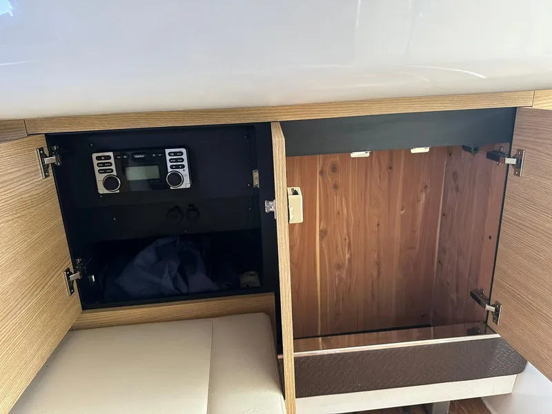 Slide: The Image of Open wooden cabinet in 2013 Chaparral 327 SSX boat, featuring a stereo system. - 41
