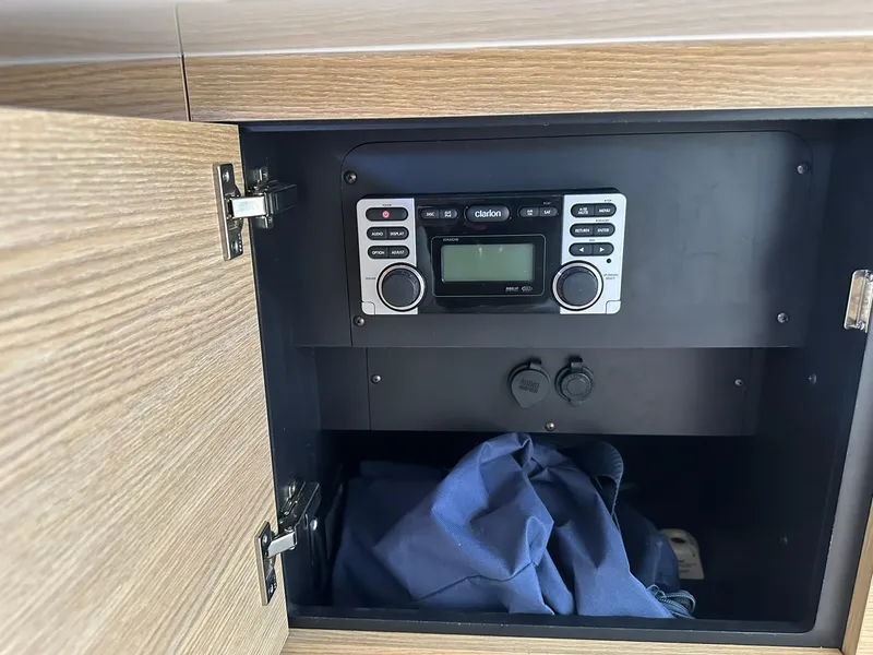 Slide: The Image of Open cabinet with Clarion stereo system in a 2013 Chaparral 327 SSX boat. - 42