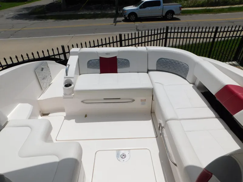 Slide: The Image of 2013 Chaparral 327 SSX boat with spacious white seating and red accents. - 45