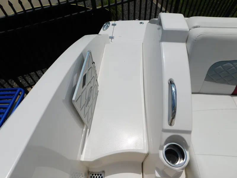 Slide: The Image of 2013 Chaparral 327 SSX boat interior with white seating and stainless steel cup holder. - 46