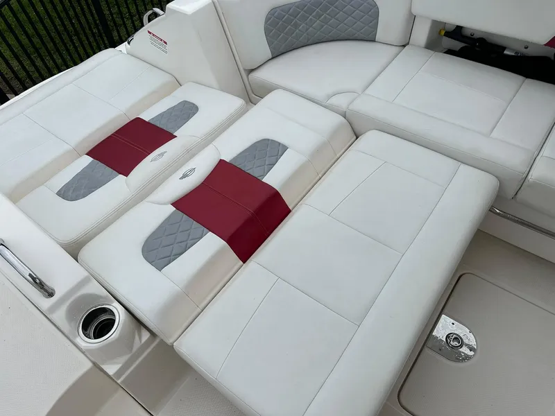 Slide: The Image of 2013 Chaparral 327 SSX boat interior with white and red cushioned seating. - 48