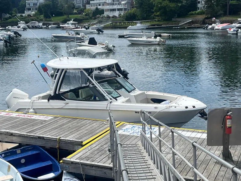 The Image of 2023 Boston Whaler 240 Vantage docked at a marina with other boats. - 0
