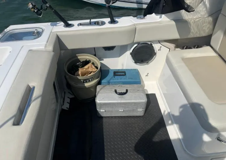 Slide: The Image of Interior of 2023 Boston Whaler 240 Vantage with fishing gear and storage. - 11