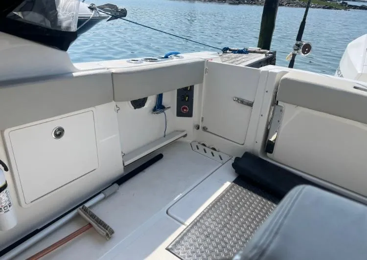 Slide: The Image of 2023 Boston Whaler 240 Vantage boat interior with storage compartments and seating. - 12