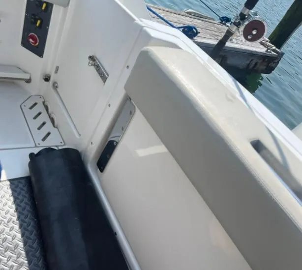 Slide: The Image of Interior view of a 2023 Boston Whaler 240 Vantage boat near a dock. - 19