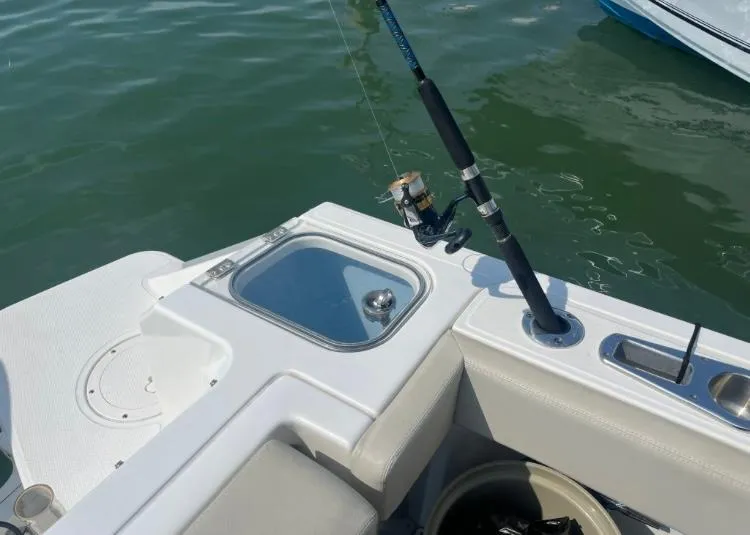 Slide: The Image of 2023 Boston Whaler 240 Vantage boat with fishing rod and bait station on deck. - 21