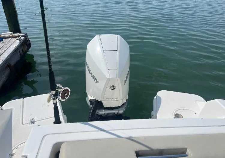 Slide: The Image of 2023 Boston Whaler 240 Vantage with Mercury outboard engine on calm water. - 22
