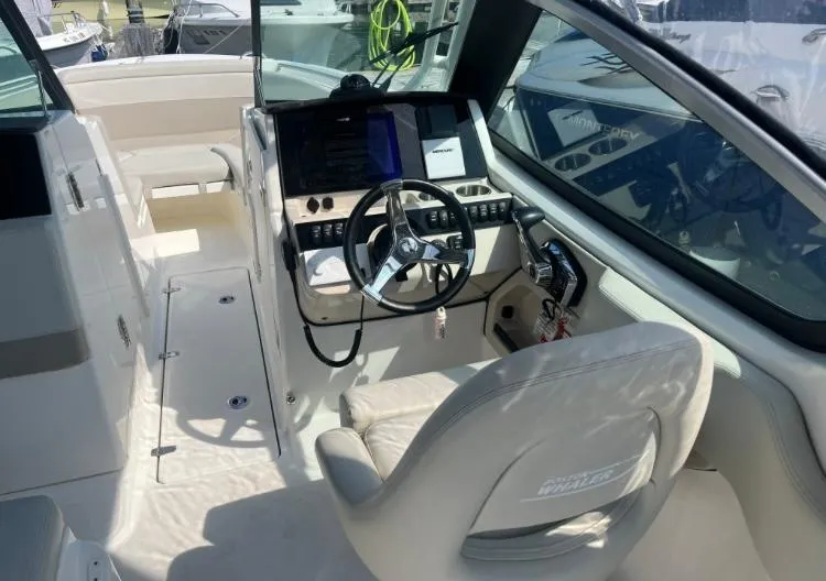 Slide: The Image of 2023 Boston Whaler 240 Vantage boat interior with steering wheel and control panel. - 9
