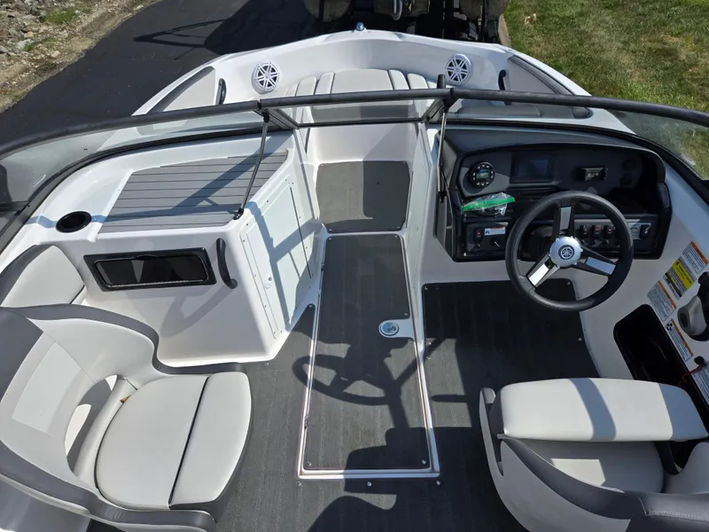 Slide: The Image of 2021 Yamaha Boats SX190 interior with steering wheel, seating, and dashboard controls. - 11