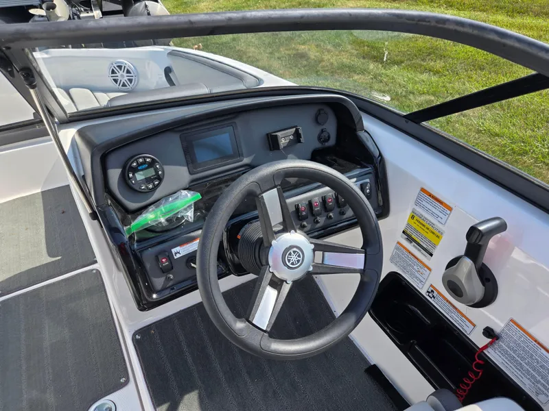 Slide: The Image of 2021 Yamaha Boats SX190 dashboard with steering wheel and control panel. - 12