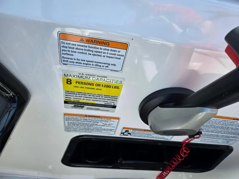 Slide: The Image of 2021 Yamaha SX190 boat warning labels and capacity information. - 13