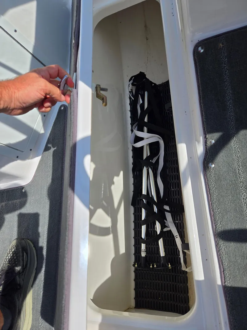 Slide: The Image of Storage compartment in a 2021 Yamaha Boats SX190, showing interior details and accessories. - 14