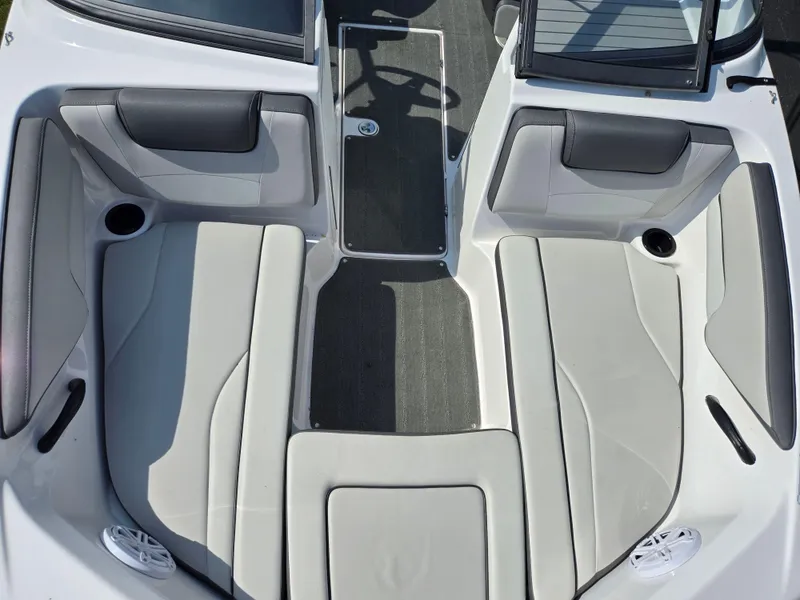 Slide: The Image of 2021 Yamaha Boats SX190 interior seating with gray upholstery and cup holders. - 18