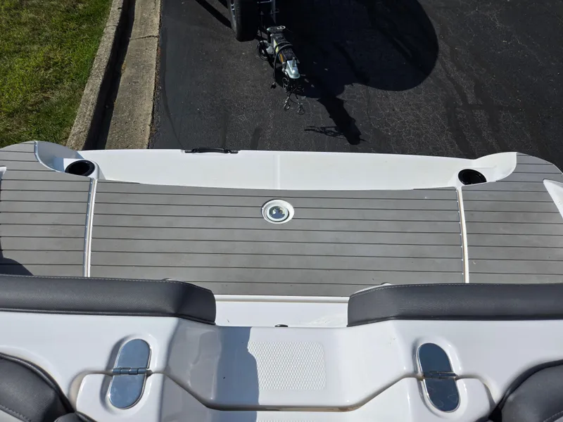 Slide: The Image of 2021 Yamaha Boats SX190 swim platform with gray decking and cup holders. - 23