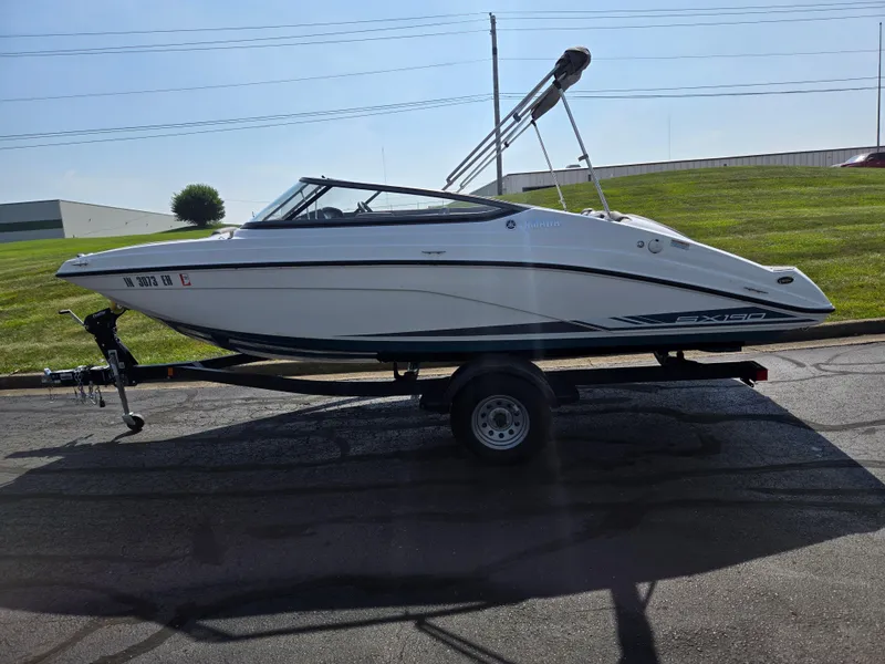 Slide: The Image of 2021 Yamaha SX190 boat on trailer, parked on a sunny day. - 4