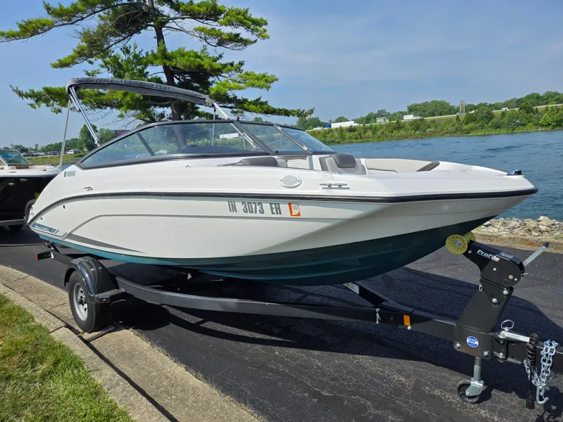 Slide: The Image of 2021 Yamaha Boats SX190 on trailer by a lakeside, ready for launch. - 8