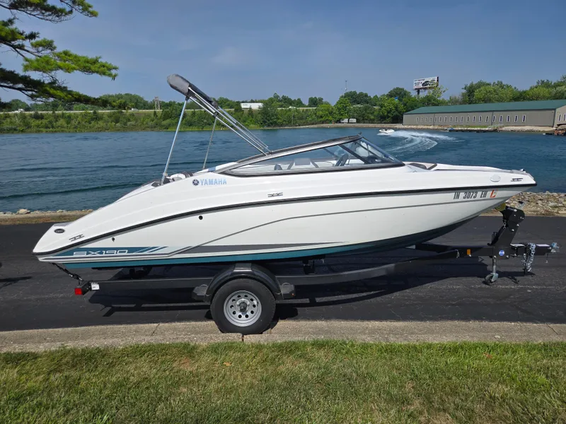 Slide: The Image of 2021 Yamaha SX190 boat on trailer by a scenic waterfront. - 9