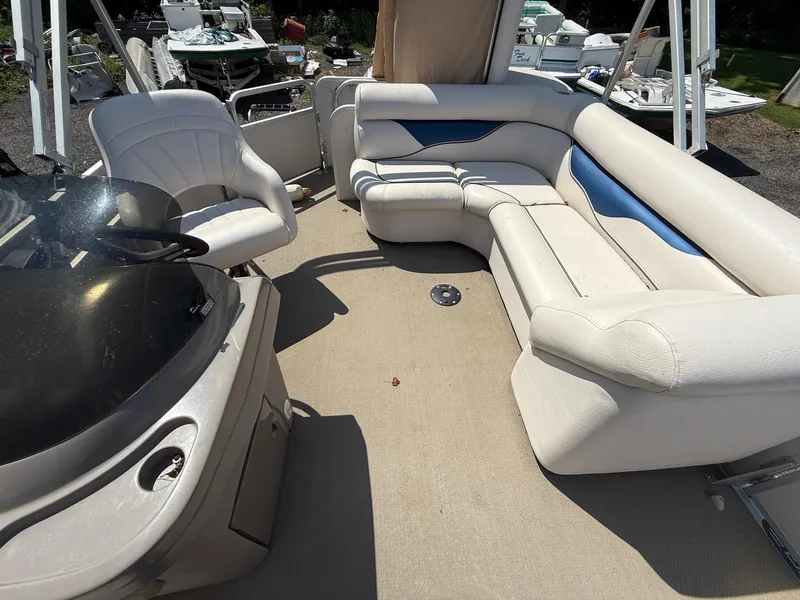 Slide: The Image of 2009 Premier 200 SunSpree boat interior with white seating and steering console. - 11