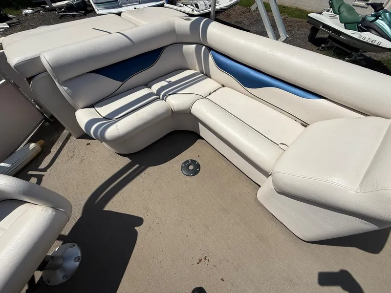 Slide: The Image of 2009 Premier 200 SunSpree boat interior with white and blue cushioned seating. - 15