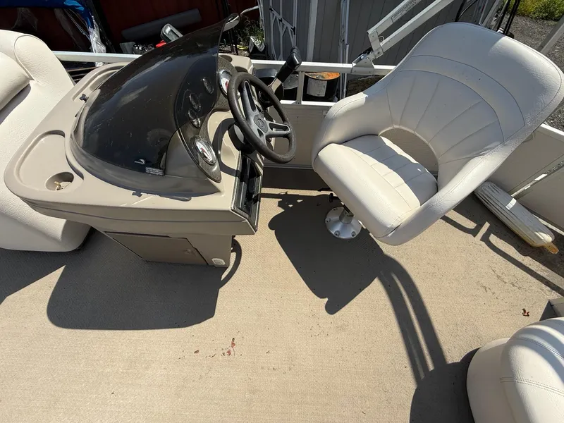 Slide: The Image of 2009 Premier 200 SunSpree boat interior with steering console and white captain's chair. - 16