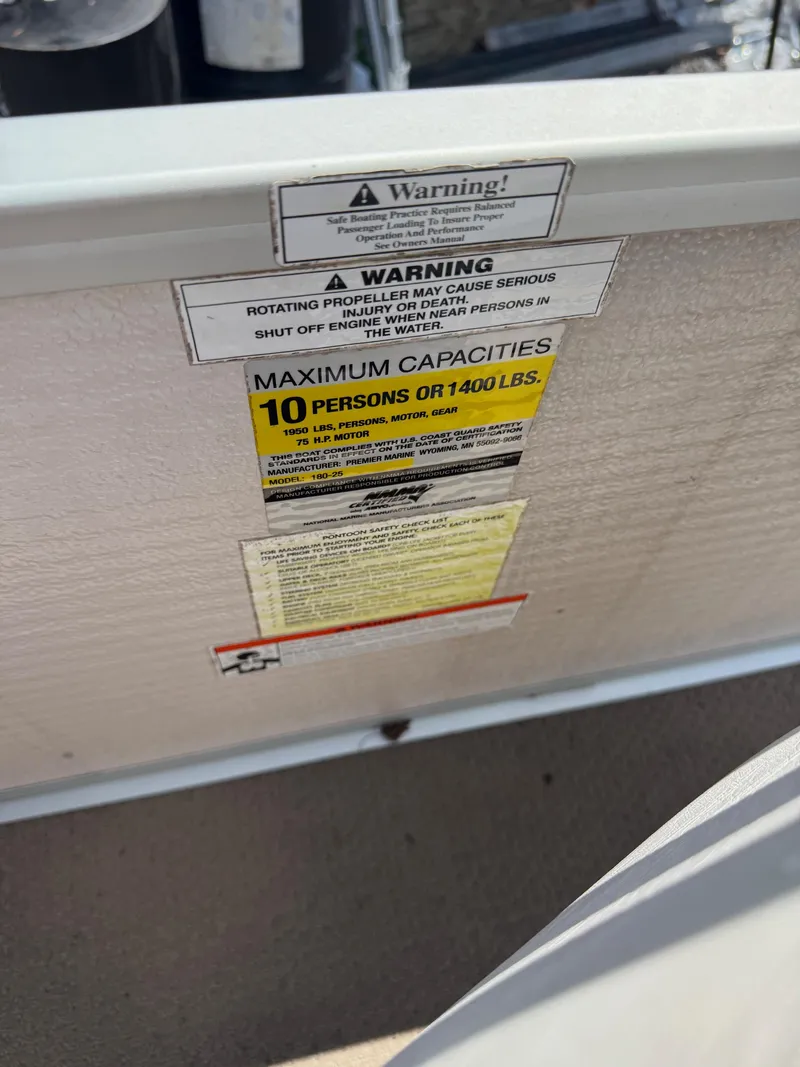 Slide: The Image of Warning labels on 2009 Premier 200 SunSpree boat, indicating maximum capacity and safety instructions. - 17