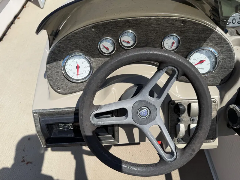 Slide: The Image of 2009 Premier 200 SunSpree dashboard with steering wheel and gauges. - 18