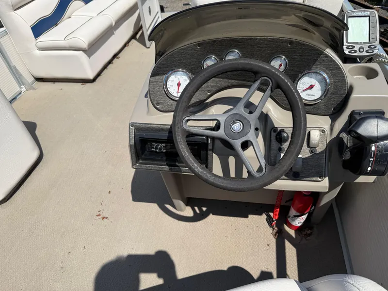 Slide: The Image of 2009 Premier 200 SunSpree boat dashboard with steering wheel and gauges. - 19