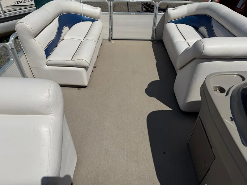 Slide: The Image of Interior of a 2009 Premier 200 SunSpree pontoon boat with white and blue seating. - 20