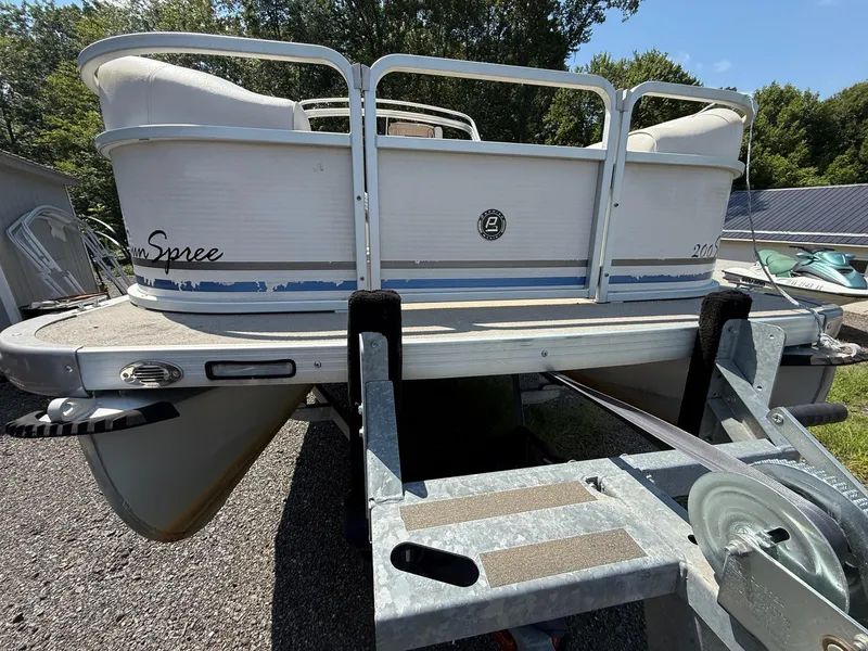 Slide: The Image of 2009 Premier 200 SunSpree pontoon boat on trailer, outdoor setting. - 8