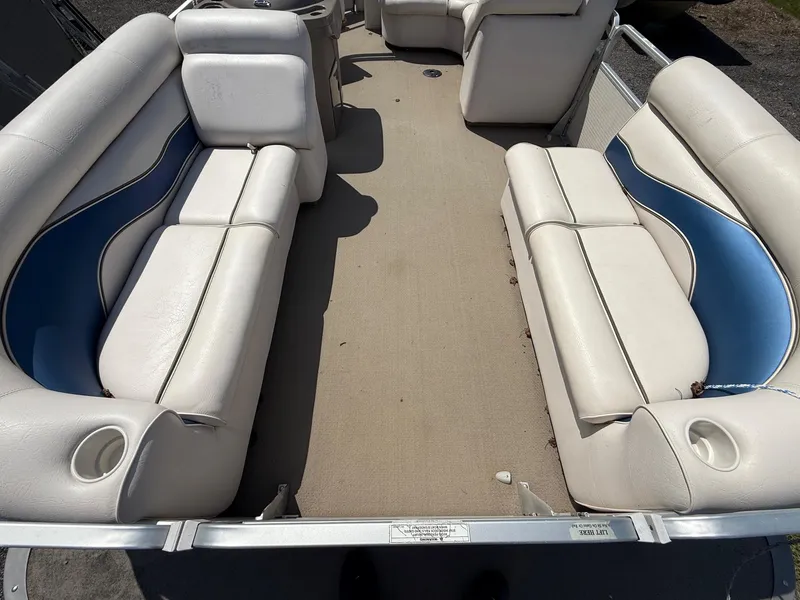 Slide: The Image of 2009 Premier 200 SunSpree boat interior with white and blue seating. - 9