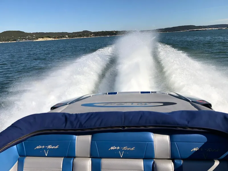 Slide: The Image of Nor-Tech 477 SPX Vee Bottom 2013 speedboat cruising on open water, leaving a wake trail. - 10