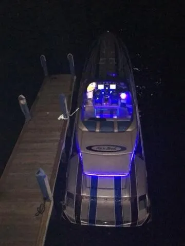 Slide: The Image of 2013 Nor-Tech 477 SPX Vee Bottom boat docked at night with blue LED lights. - 14