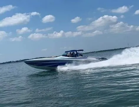 Slide: The Image of 2013 Nor-Tech 477 SPX Vee Bottom speedboat cruising on open water under a clear sky. - 15