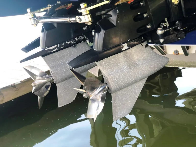 Slide: The Image of 2013 Nor-Tech 477 SPX Vee Bottom boat propellers in water, showcasing sleek design. - 16