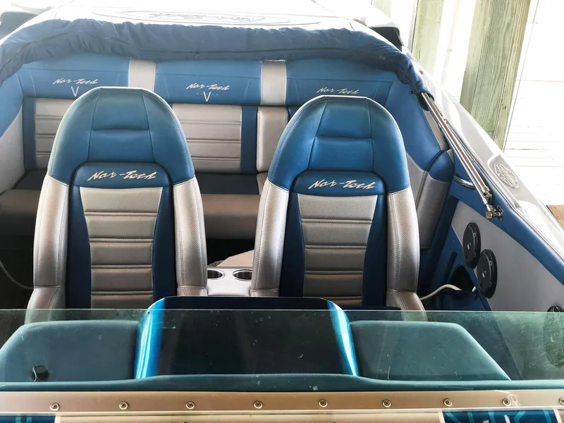 Slide: The Image of 2013 Nor-Tech 477 SPX Vee Bottom boat interior with blue and silver seating. - 22